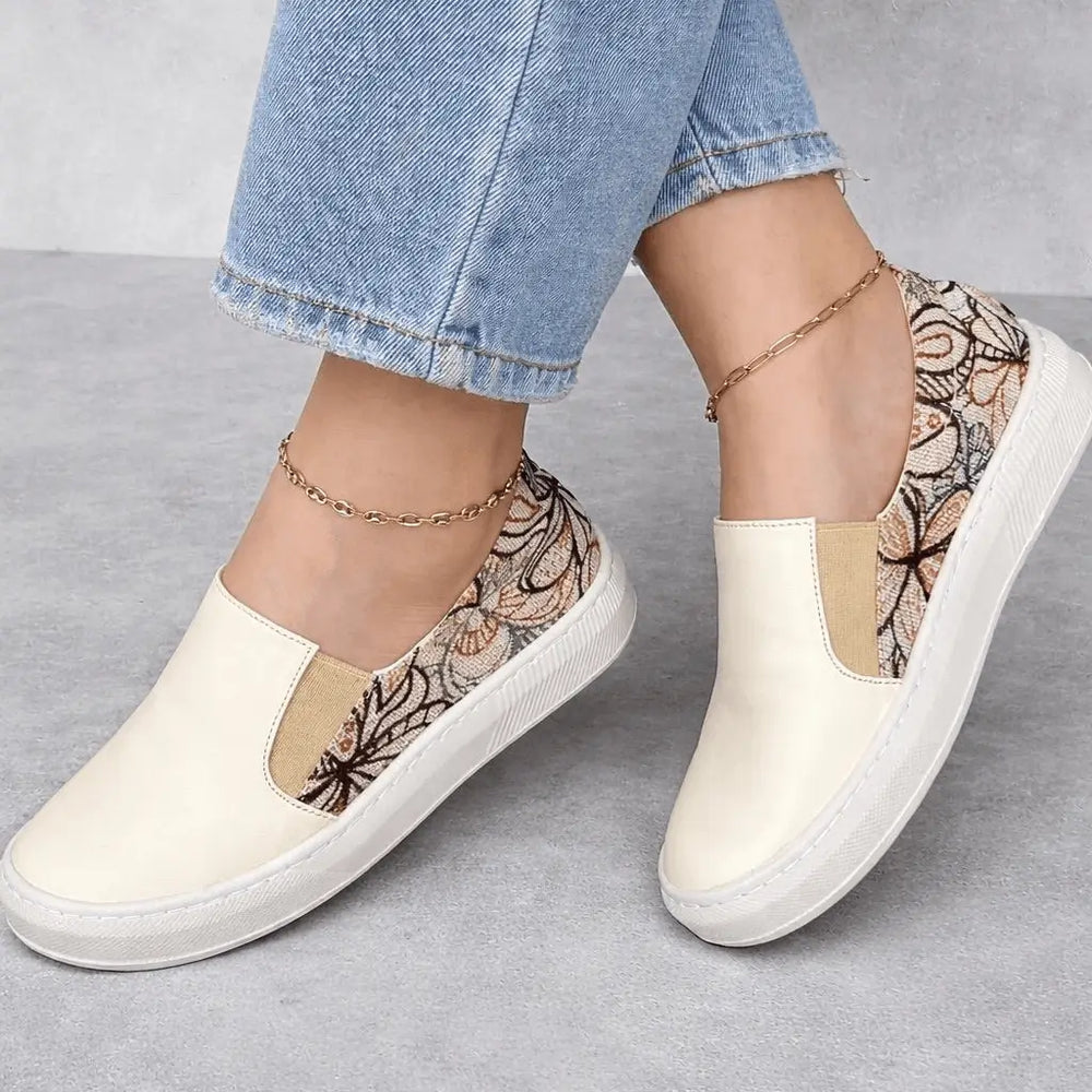 Bolichero Nayara zapato slip-on femenino color crema con estampado floral en talón, suela ligera antideslizante y plantilla acolchada para máxima comodidad diaria.