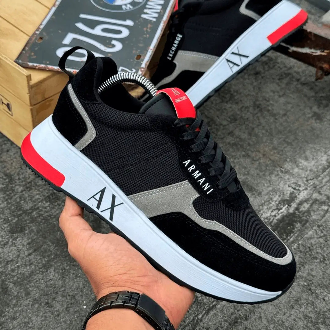 Tenis Urbano negro y gris con detalles rojos, diseño moderno y cómodo, suela blanca con amortiguación que brinda soporte ideal para caminar y actividades diarias, material resistente y transpirable para mayor durabilidad y frescura, calzado perfecto para estilo urbano y casual en Colombia.