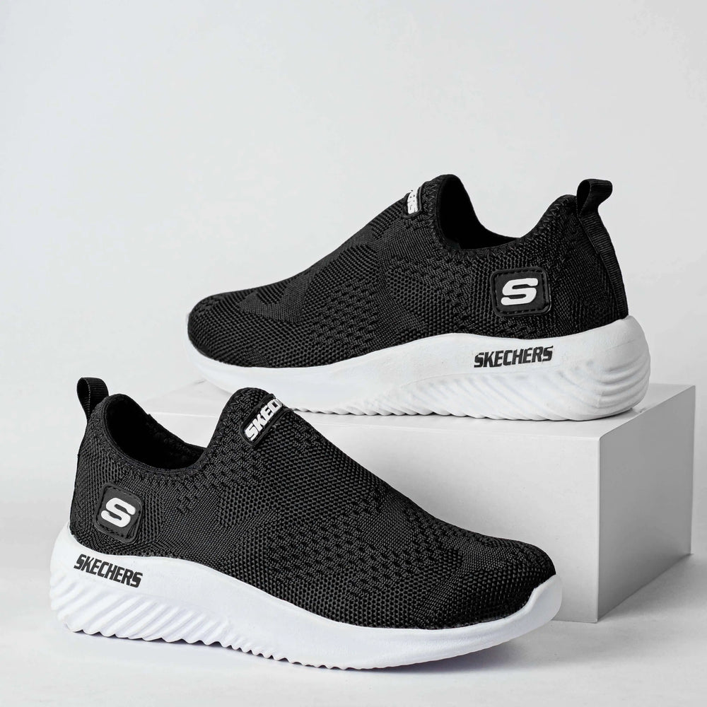 Zapatillas deportivas negras para hombres y mujeres con suela blanca antideslizante, diseño ligero y transpirable, ideales para uso diario y actividades casuales, ofreciendo comodidad y flexibilidad superior para el pie.