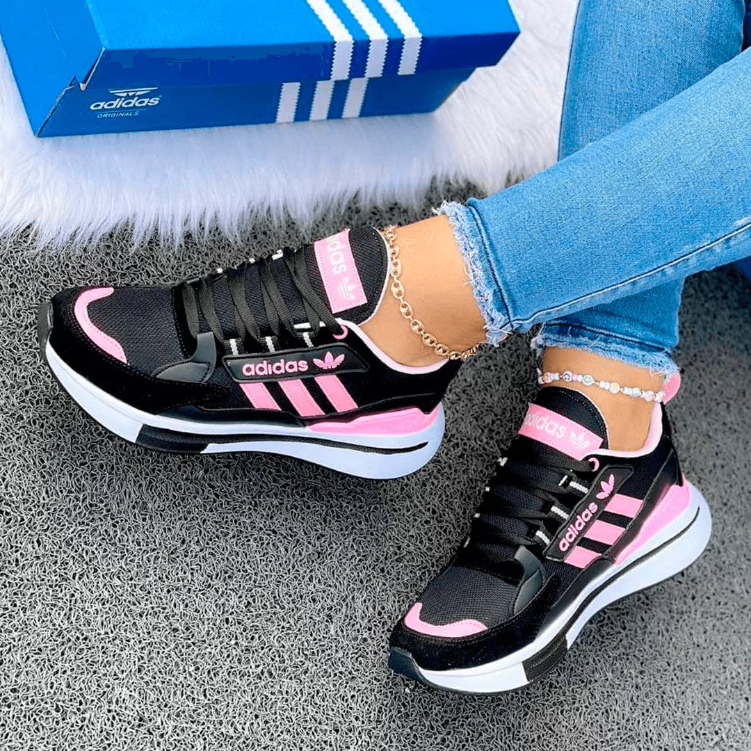 Tenis Fit Pro color negro con detalles fucsia y suela blanca, diseño llamativo con aire deportivo y urbano