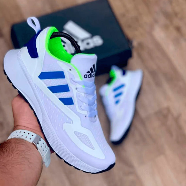 Tenis blancos con detalles en azul vibrante, estilo moderno y funcional para correr o caminar con comodidad.